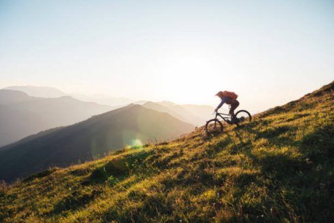 Mountain biker riding downhill in the mountains.